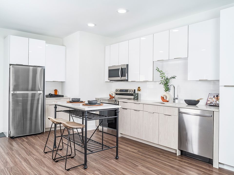 Alluring kitchens feature quartz countertops, charming tile backsplashes, and custom-built 42-inch cabinetry.