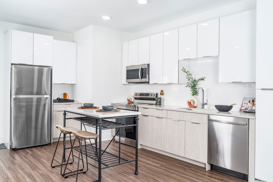 Alluring kitchens feature quartz countertops, charming tile backsplashes, and custom-built 42-inch cabinetry.
