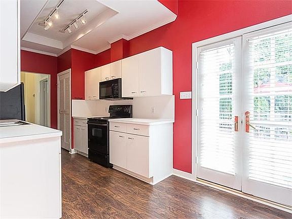 Clean and contemporary kitchen with just enough of a splash of red to energize the cook!  The sky light above the breakfast area to the right adds just enough light to brighten the entire area.  French doors lead to the large back deck.