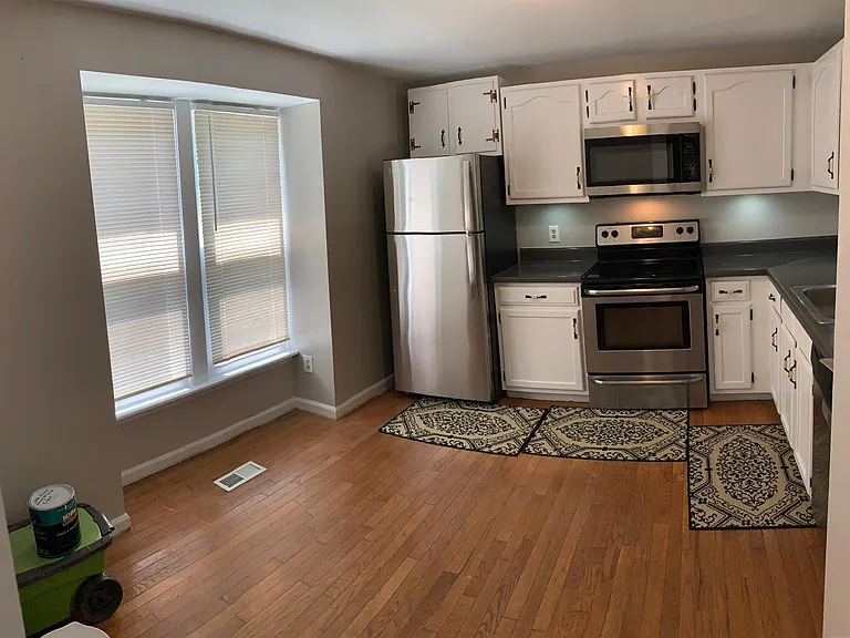 Kitchen, with front door and front view windows to left