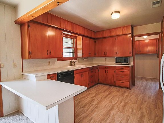The kitchen provides plenty of storage and leads into the utility room.