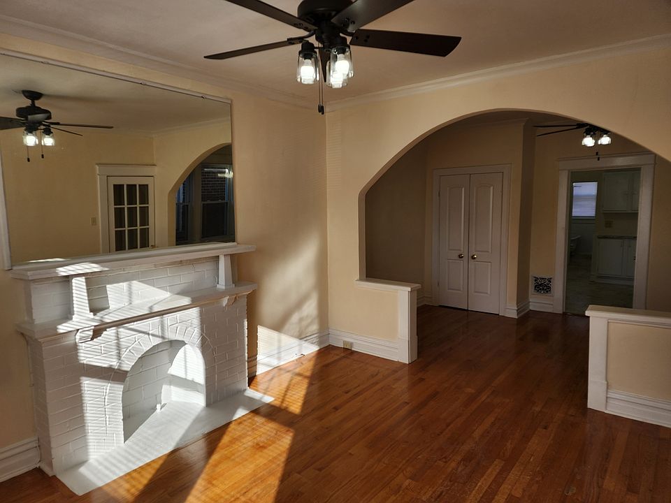 Front Room Looking into the Middle room with hardwood floors and connecting archway