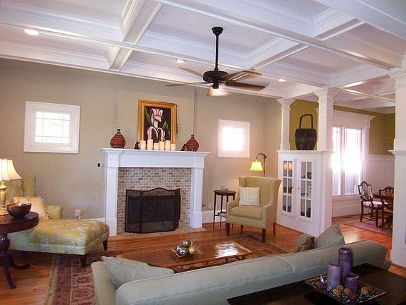 Formal living room features a cozy gas fireplace, coffered ceiling, built-in cabinets... the list go