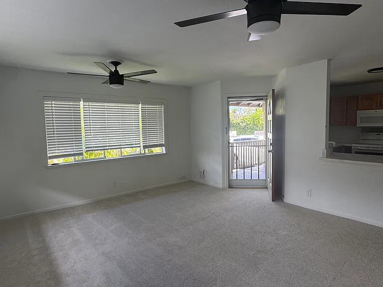 Family room. Kitchen overlooks into the living area with a nice little island. New ceiling fans, blinds, screen door & carpet.