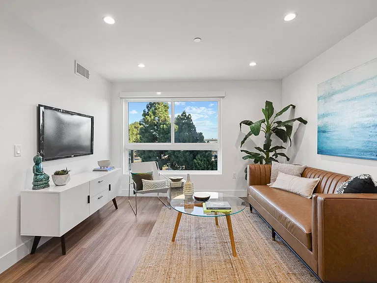 Spacious Living Rooms with Vinyl Flooring, Recessed Lighting, and Natural Light