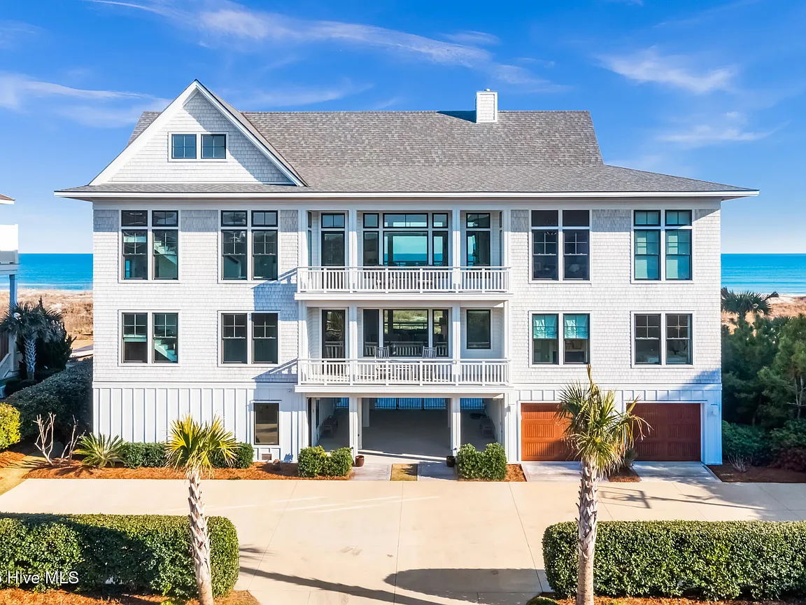 Aerial view of a luxury coastal home in North Carolina with a pool and ocean access, representing high-end real estate