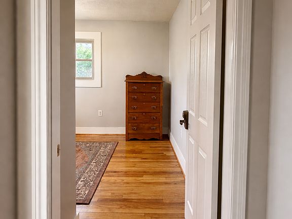 View from hallway into room - note additional space and dresser.