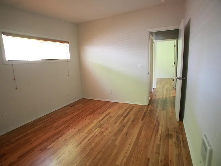 larger bedroom facing hallway to second better and bathroom
