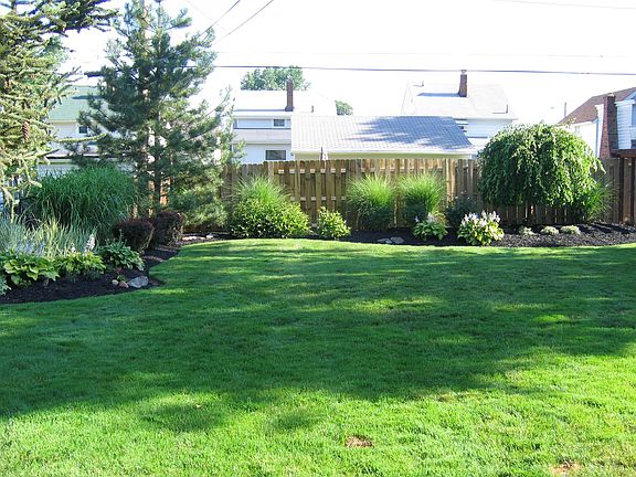manicured landscaped fenced yard