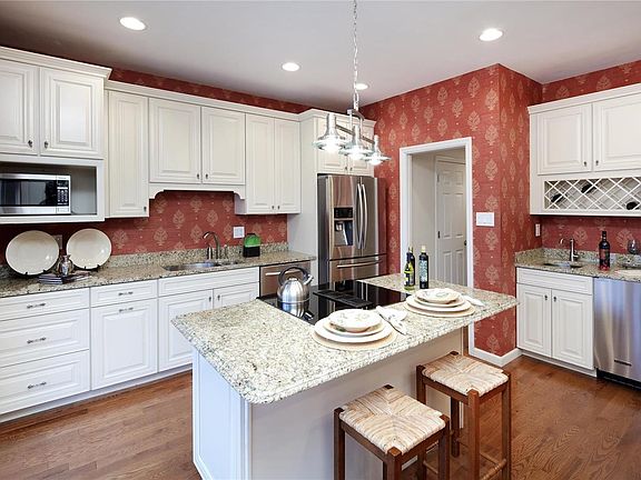 Center island, abundant granite counters and a wet bar - makes for easy living.