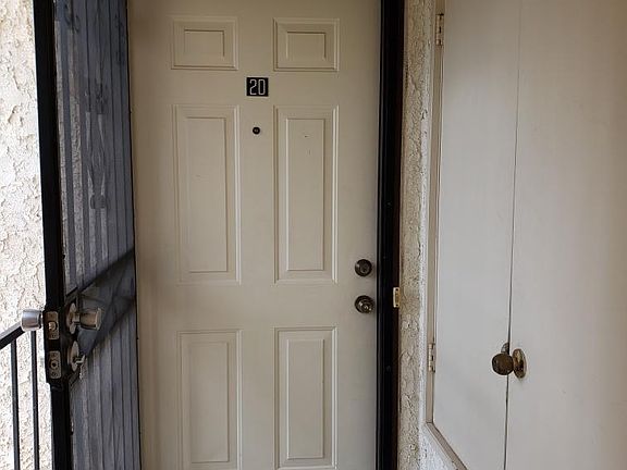 Front door of Unit 2D with security screen door.