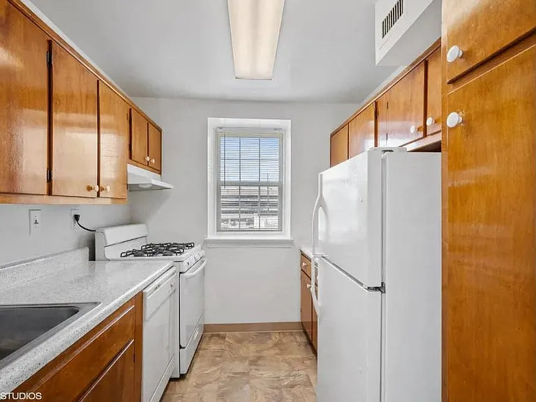 Rich wood cabinets and a gas stove