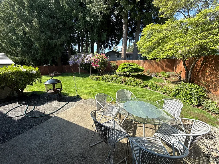 View of the backyard from the NE corner of the house. Yard is completely fenced (6' high). Gate on the side to access the front yard.