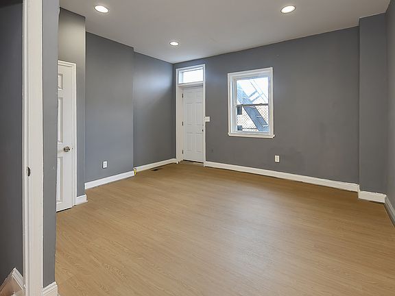 Bedroom 2, tucked just off the rear of the unit, serves as a private retreat. Its quite location ensures a peaceful atmosphere, making it the perfect space to unwind and recharge."