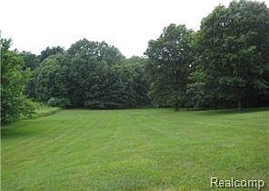 WOODED ACROSS BACK OF 3 ACRES