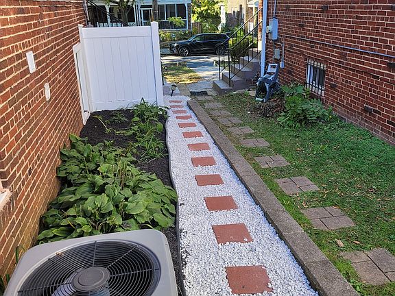 view of sideyard pathway leading backyard entrance to 4621 12th St., NE #B