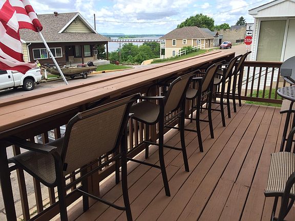 Two outdoor barstools and four chairs included on huge deck.