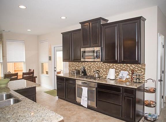 Upgraded kitchen. Glass door leads to extended covered pati