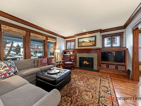 Living room with beautiful woodwork & fireplace
