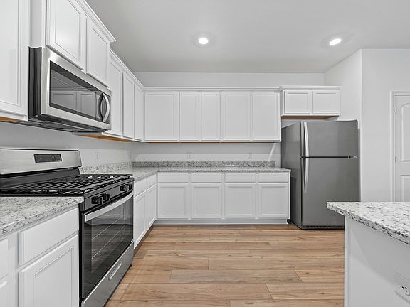 The kitchen is filled with stainless steel appliances!