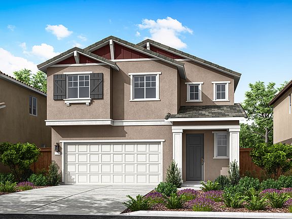 A two-story residential house with a garage, surrounded by lush greenery and a paved driveway, set a