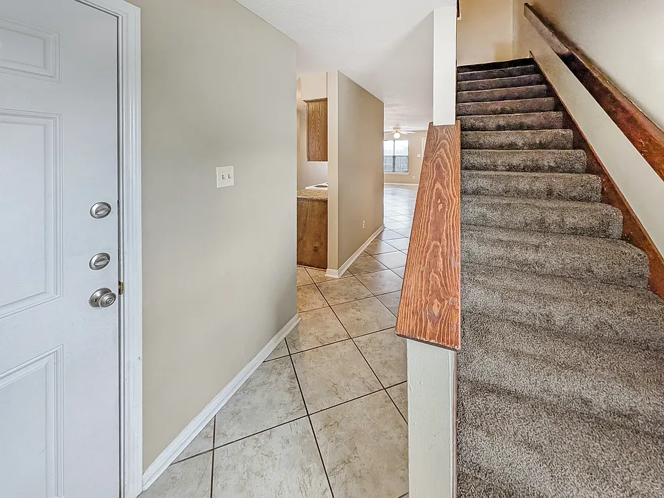 Welcome home! This spacious College Station entry features tile floors and easy upstairs access.