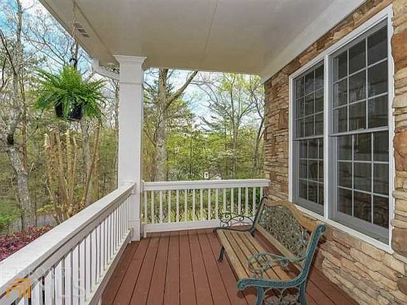 Serene stone accented rocking chair front porch ideal for afternoon lemonade