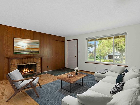Living room retains some of the mid century charm and also features a small mountain view from the front window