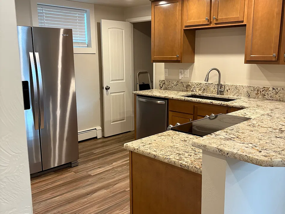 Kitchen view, open door goes to storage space under stairs.