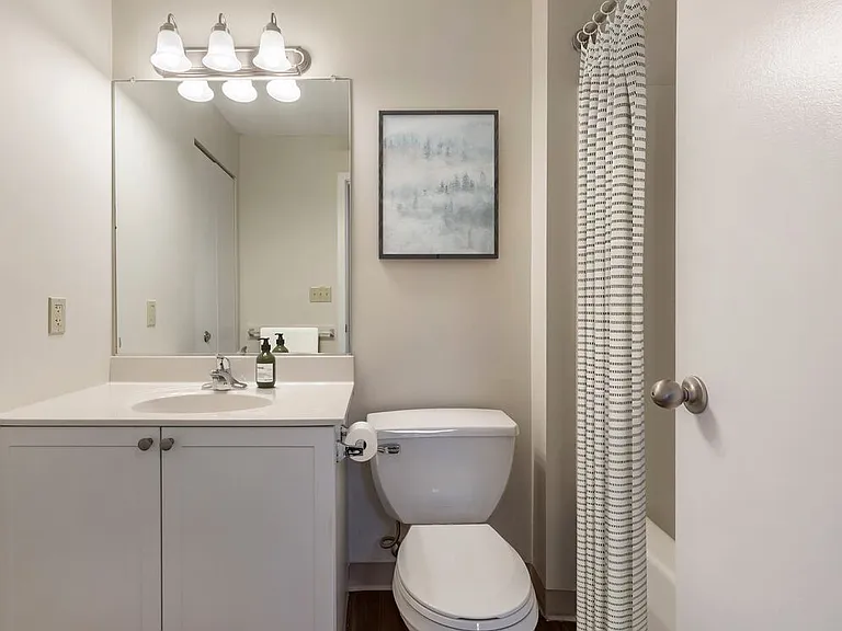Classic Package I bath with white laminate countertops, white cabinetry, and hard surface flooring
