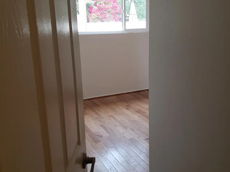 This is the entry into a nice size bedroom with mirror closet doors and private height window overlooking private outside drive