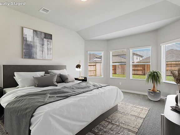 The primary bedroom of a home in Wall Street Village of Richmond, TX.