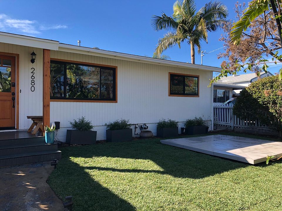 front yard with grass area and deck.