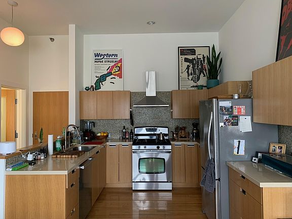 Kitchen area view, taken from the open-floor-plan living room. The bedroom is to the right.