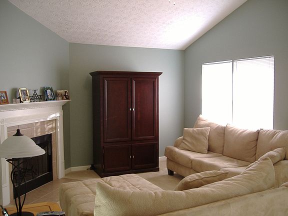 Living Room w/ fireplace and vaulted ceilings. 