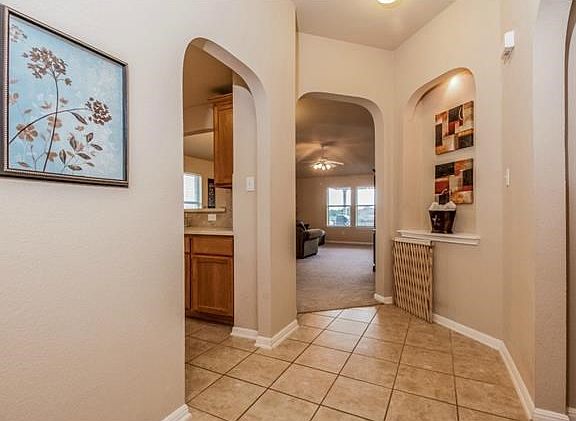 Attractive contemporary hard tile in the foyer extends into the