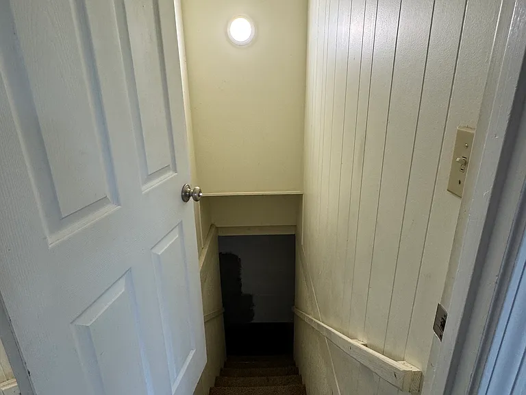 Stairs going from upper floor hallway to downstairs basement/garage