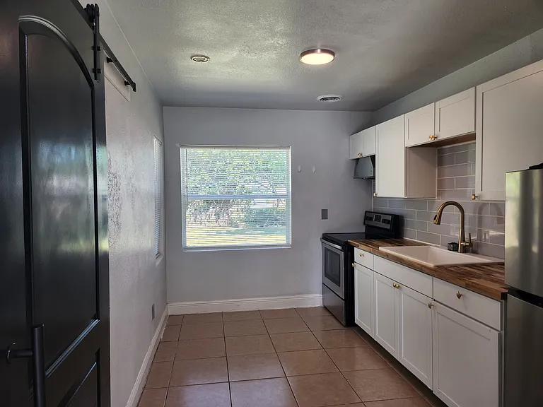 Bedroom 3, Den, or Family behind black barn door