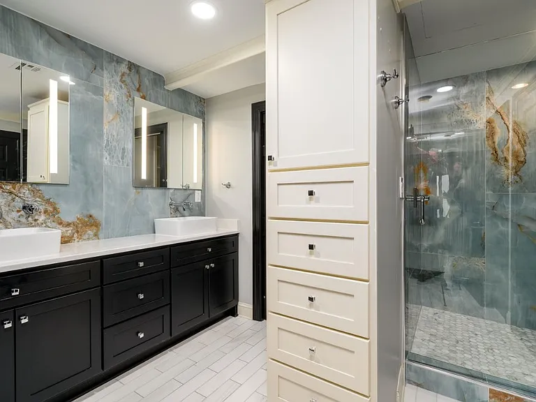 Master bathroom with double sicks and marble walls. Large walk in shower. Double closet.