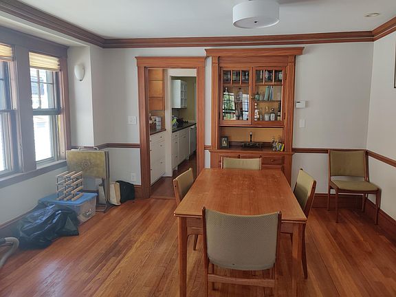 dining room with built-in, butler's pantry and kitchen through doorway