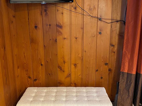 TV mounting with swing arm on wall. Can be viewed from LR, eating area and kitchen! This ottoman provides extra seating and storage