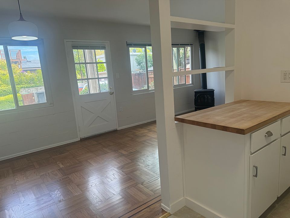 Open floor plan to living room with gas fireplace