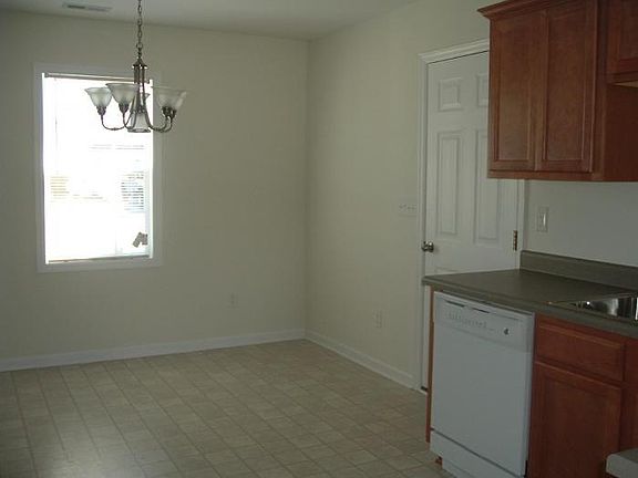 KITCHEN VIEW SHOWING EAT-IN KITCHEN AREA (garage door to right)