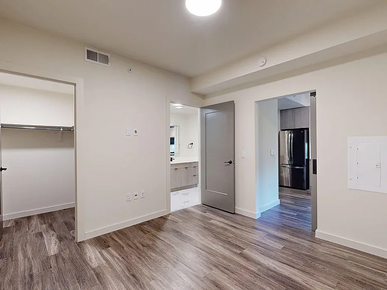 Spacious apartment Bedroom with Large Closet and Wood Style Flooring.
