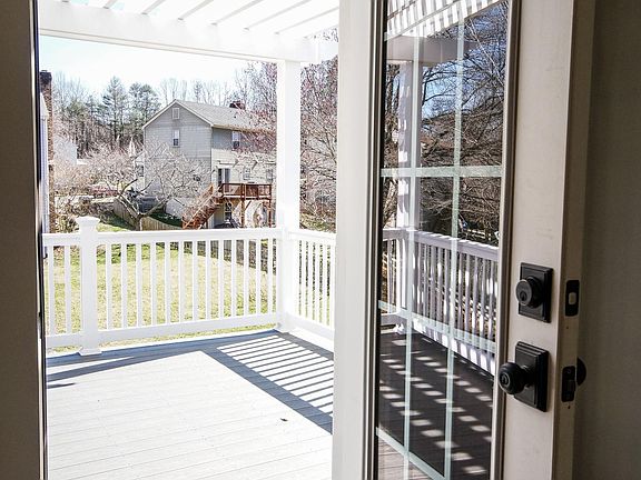 View from kitchen/dining area to upper porch with pergola.