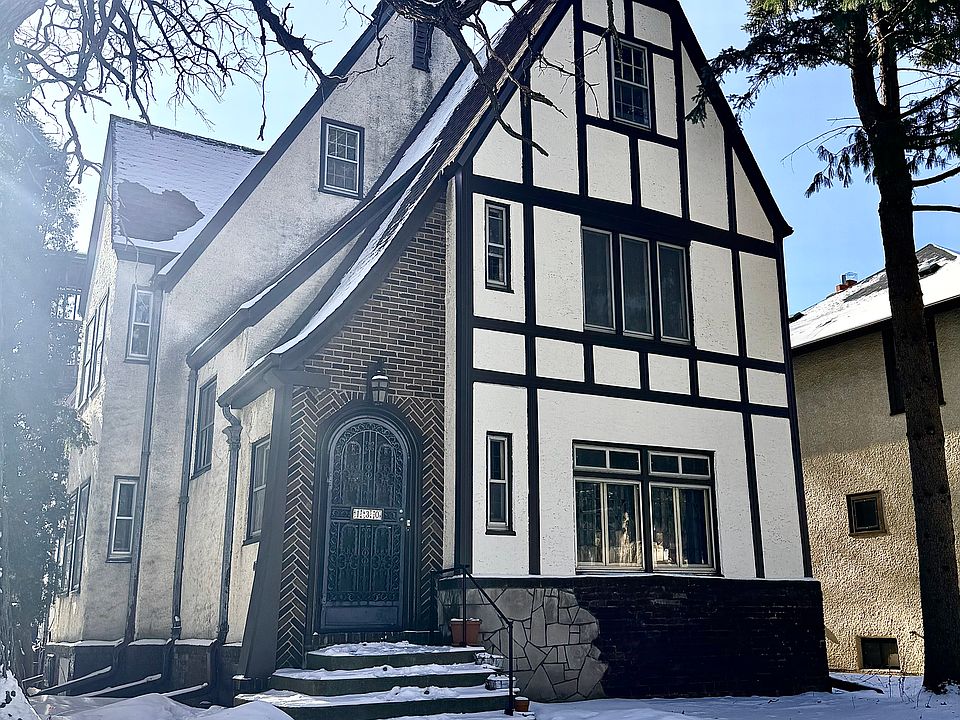 Charming Tudor-Style Home w/ Stucco and Brickwork Exterior