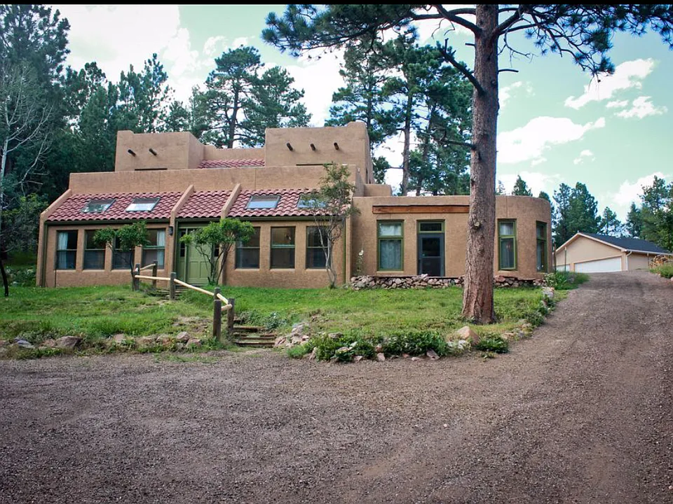 Parking and main house - south facing. Passive solar home with all main windows facing south and radiant floor heat. Flat top section is mother-in-law apartment unit, being leased currently by a single occupant. NO interior passage between units.