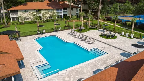 An enchanting aerial view of our resort-style pool and expansive sundeck, promising endless fun. - Carrington Lane