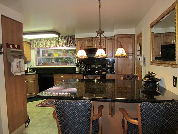 Open kitchen with granite counters & maple cabinets