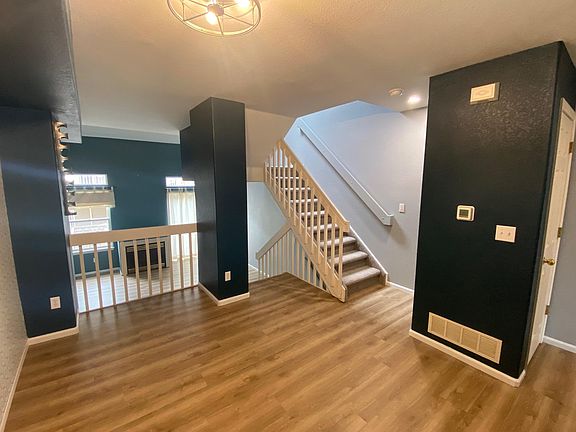 Dining Room with stairs leading up to Master Bedroom Suite. Stairs down to the living room.